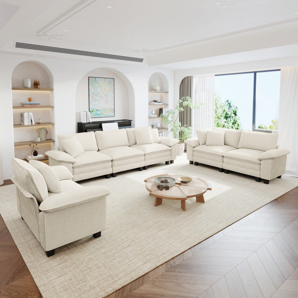 Modern living room with white  beige corduroy sectional cloud sofa, a coffee table, and decorative elements.