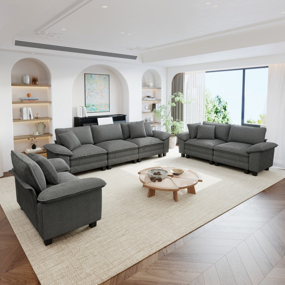 Modern living room with 6-seater gray sectional sofa and round coffee table.